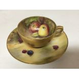 A Royal Worcester hand painted small cup and sauce