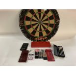 A Winman darts board plus six sets of vintage darts, complete with shafts, flights, boxes and