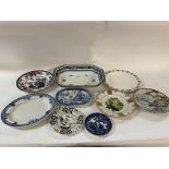 A collection of plates, including makers such as W
