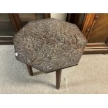 A carved oak hexagonal table with acorn and oak le