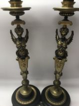 A pair of Empire style candle sticks in the form o