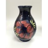 A Moorcroft anemone vase, monogrammed WM to base, approx height 19cm.