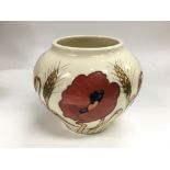 A boxed Moorcroft vase of ovoid form decorated with flowers on an ivory coloured ground,