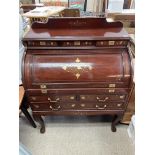 An imported mahogany domed roll top desk with bras