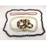 Four necklaces comprising Lapis Lazuli, coral, amb