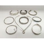 A collection of mainly silver bangles.