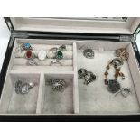 A jewellery box of silver jewellery items.