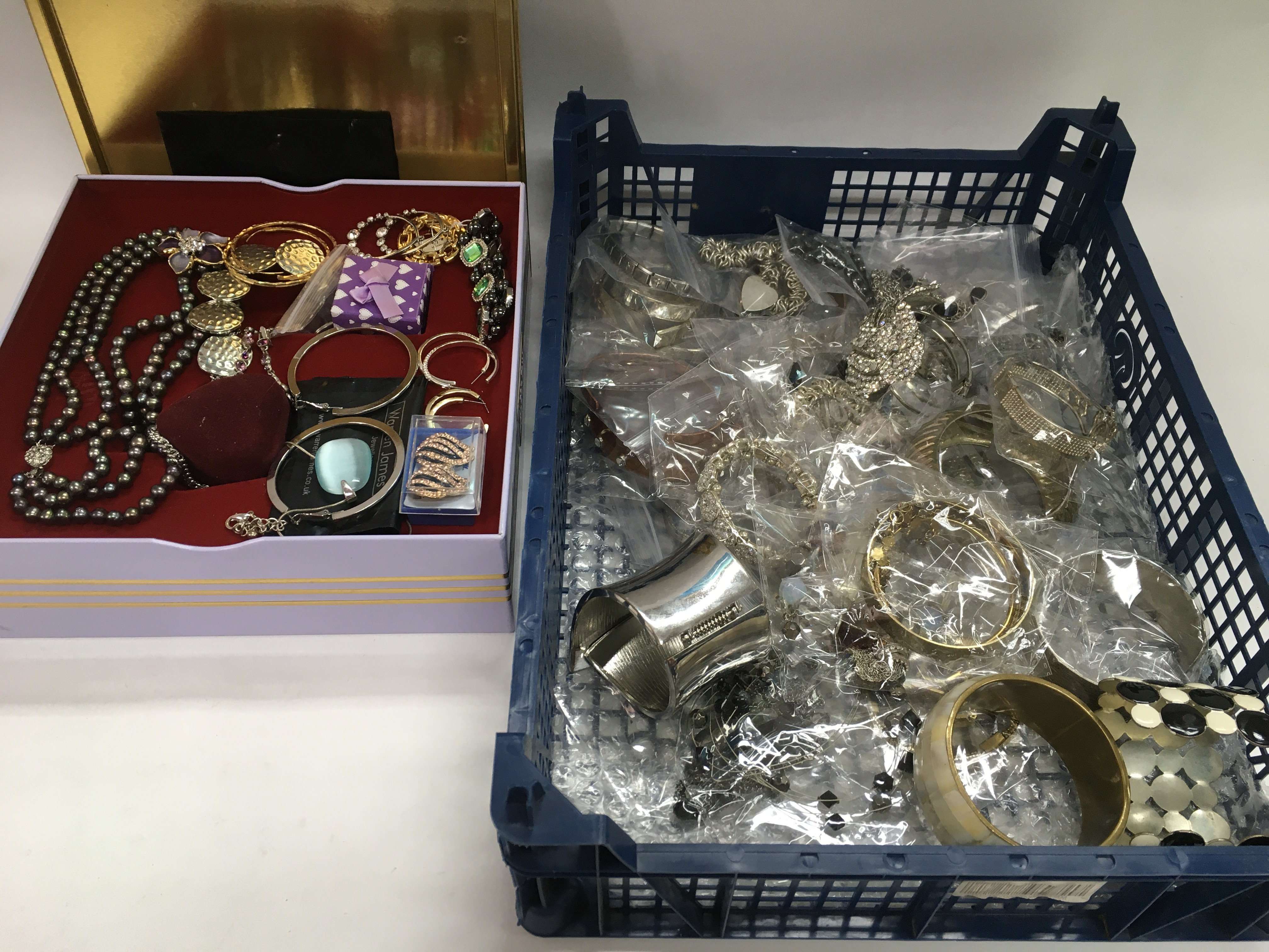 A collection of costume jewellery in three trays a