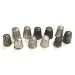 A collection of eleven silver thimbles to include two Charles Horner examples.
