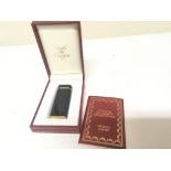 A Cartier lighter in a fitted box with certificate of authenticity.