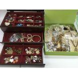A collection of costume jewellery in a wooden jewe