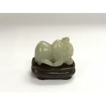 A jade figure of two peaches and a monkey raised o