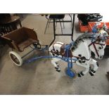 A wood and metal peddle driven horse and cart, app