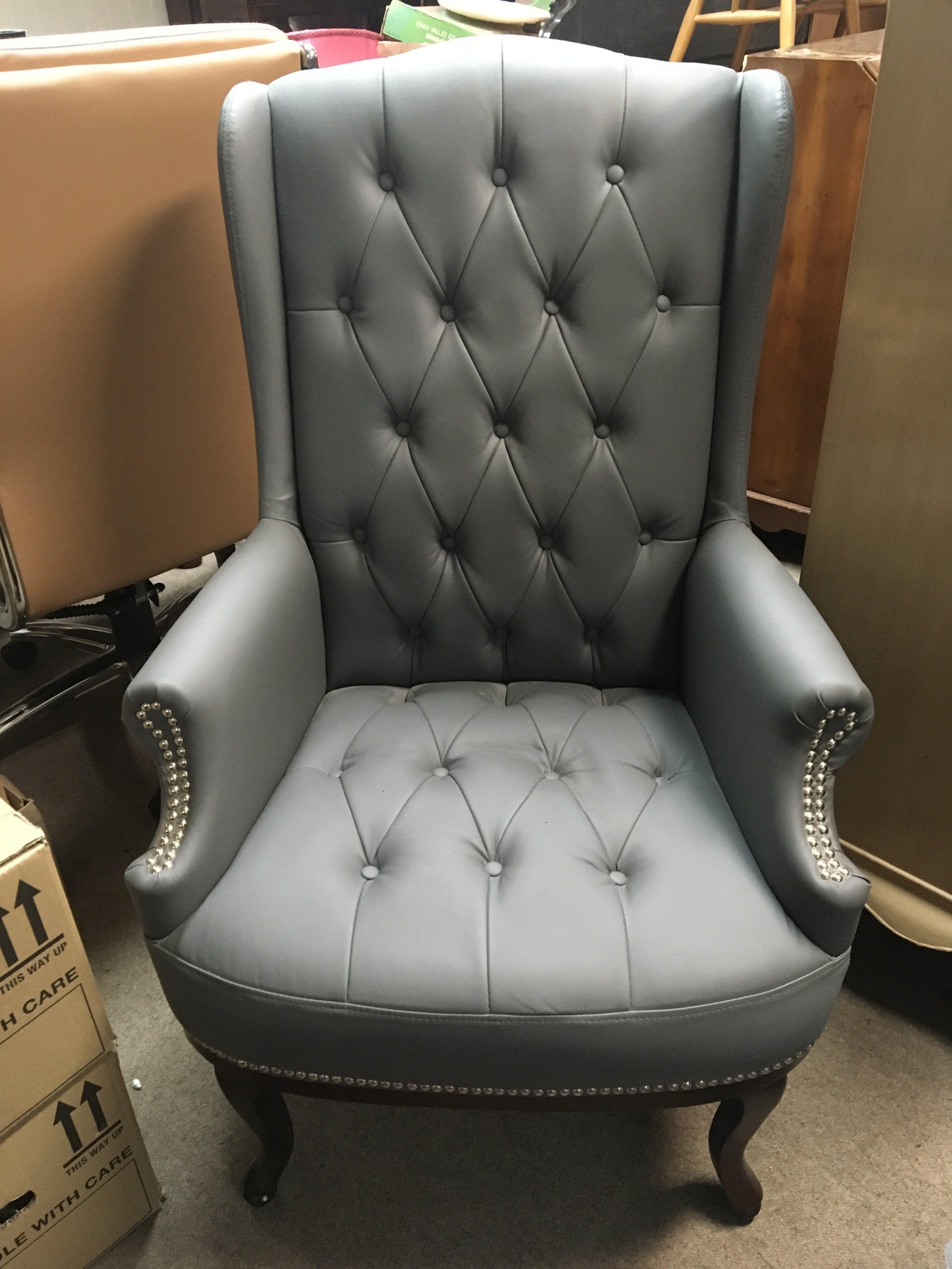 A leather upholstered wing arm chair with cabriole