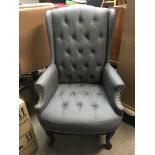 A leather upholstered wing arm chair with cabriole