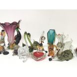 A collection of Murano glass animal ornaments and other glassware.