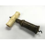 A Victorian bronze and bone handled corkscrew.