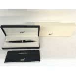 A Mont Blanc pen with box and service guide.