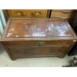 An oriental design camphor wood chest.