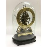 A brass skeleton clock under a glass dome, approx