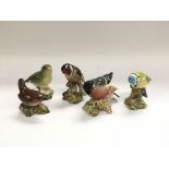 Five Beswick figures of birds.