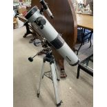 A modern telescope with adjustable tripod.