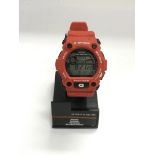 A Casio G Shock sports gear watch and stand.