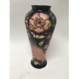 A Moorcroft vase decorated with flowers and foliag