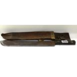 A military issue bayonet with leather sheath dated