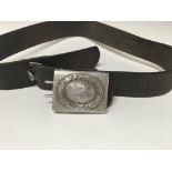 A German belt buckle with leather belt .