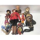 Collection of various vintage puppets and dolls in