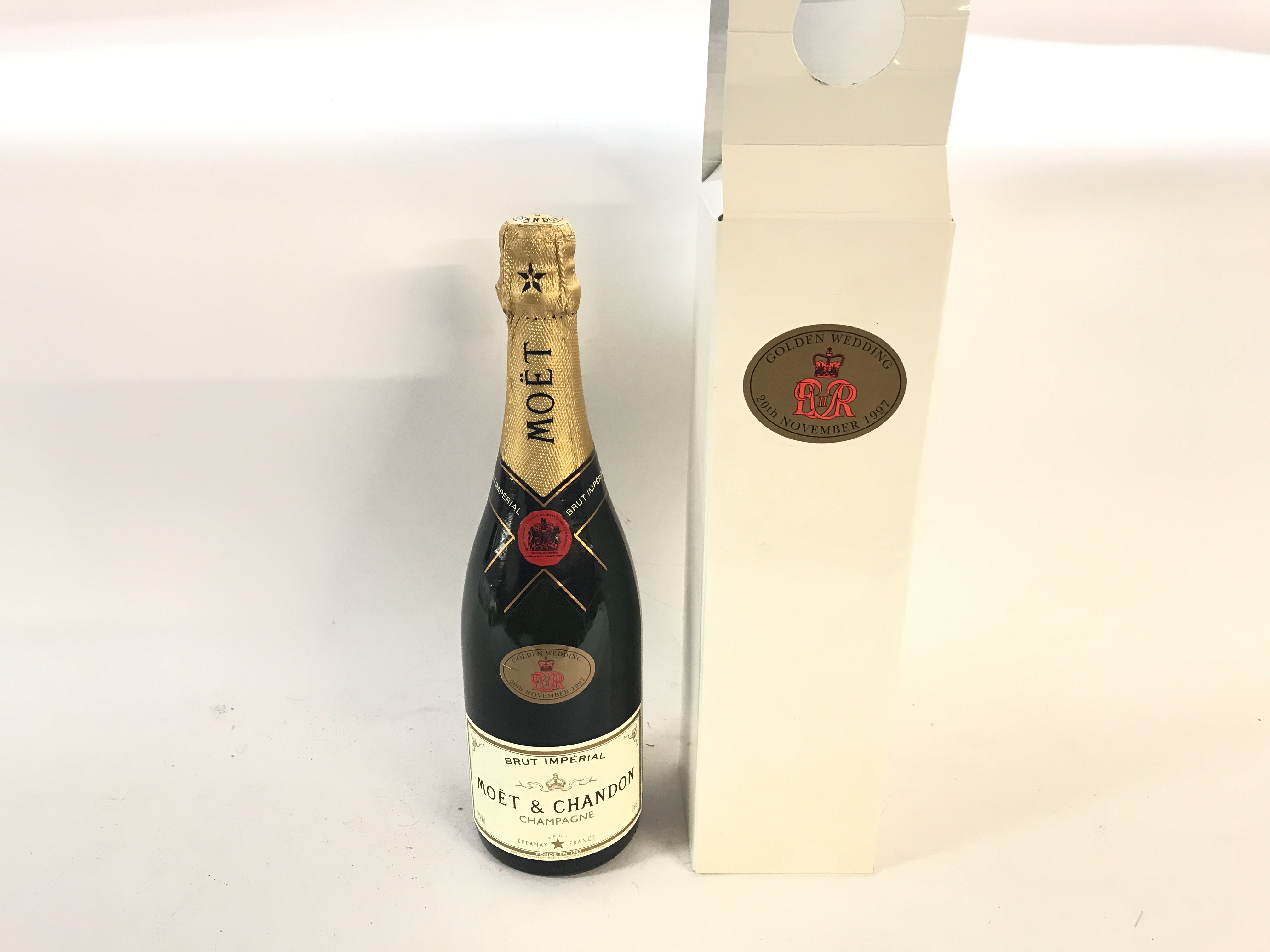 A moet & chandon bottle of champagne boxed for gol