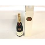 A moet & chandon bottle of champagne boxed for gol