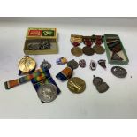 A collection of mixed military badges, medals etc.