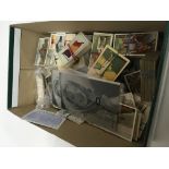 A box containing loose cigarette cards some comple