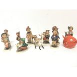 A collection of vintage ceramic Hummel figures and other oddments.