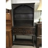 An 19thC oak dresser with barley twist support leg