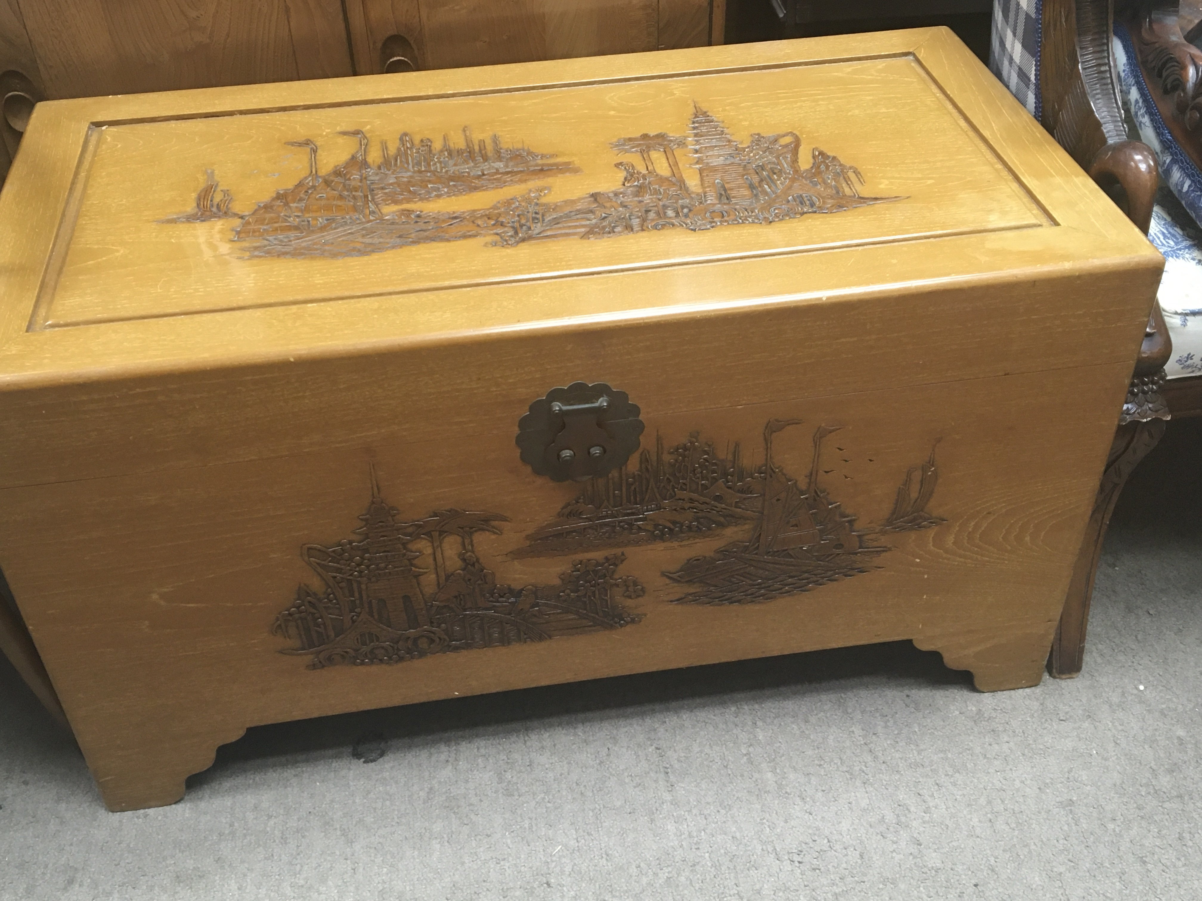 A large carved camphor wood trunk with a rectangul