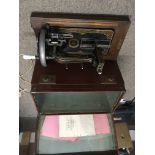 A vintage cased Singer sewing machine with instruc