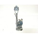 A large Lladro figure of a man lighting a street gas lamp no damage. Height 48cm