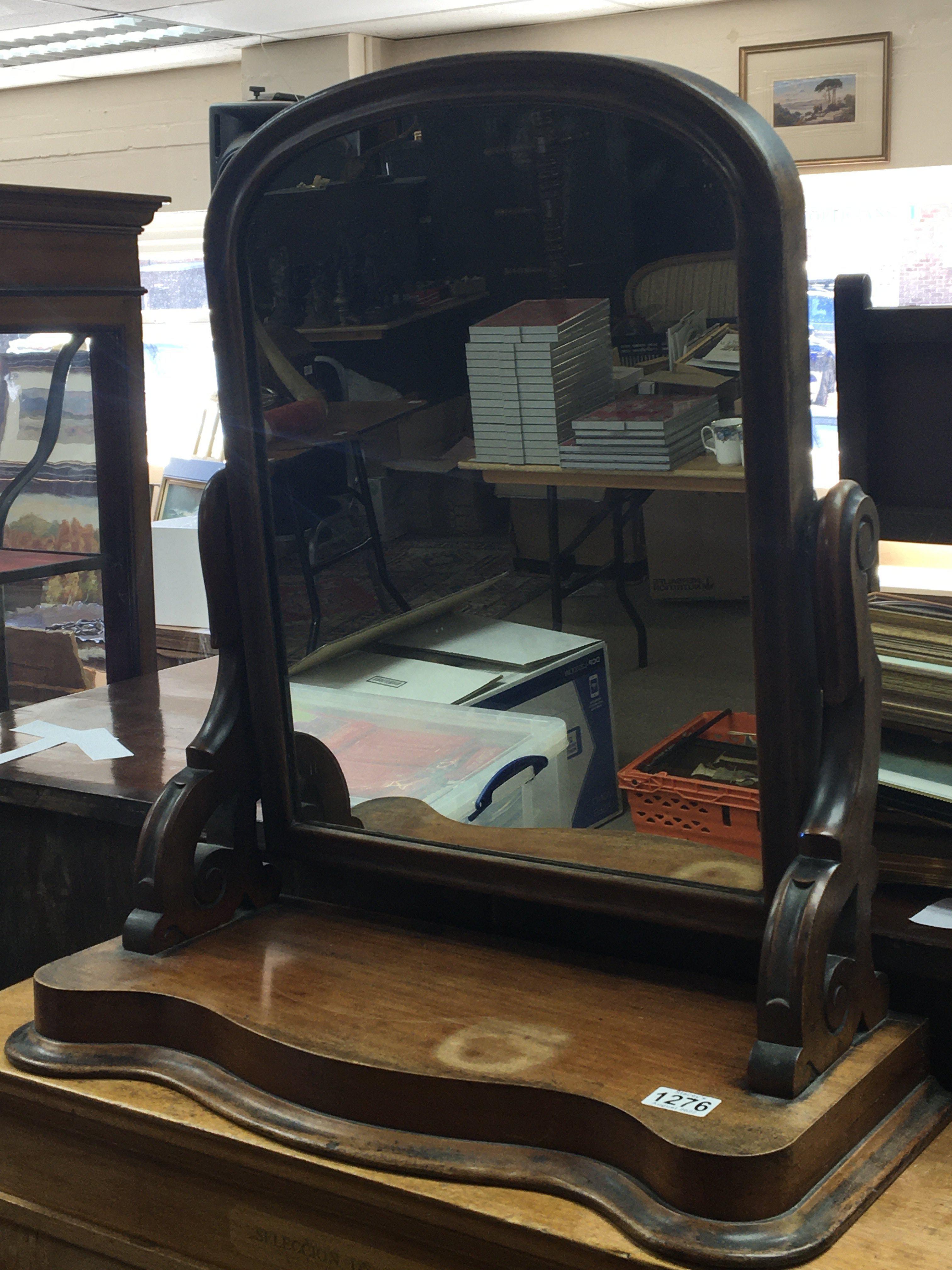 A Victorian mahogany dressing mirror with shaped s