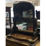 A Victorian mahogany dressing mirror with shaped s