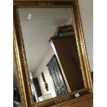 A decorative modern gilt wood mirror of rectangula