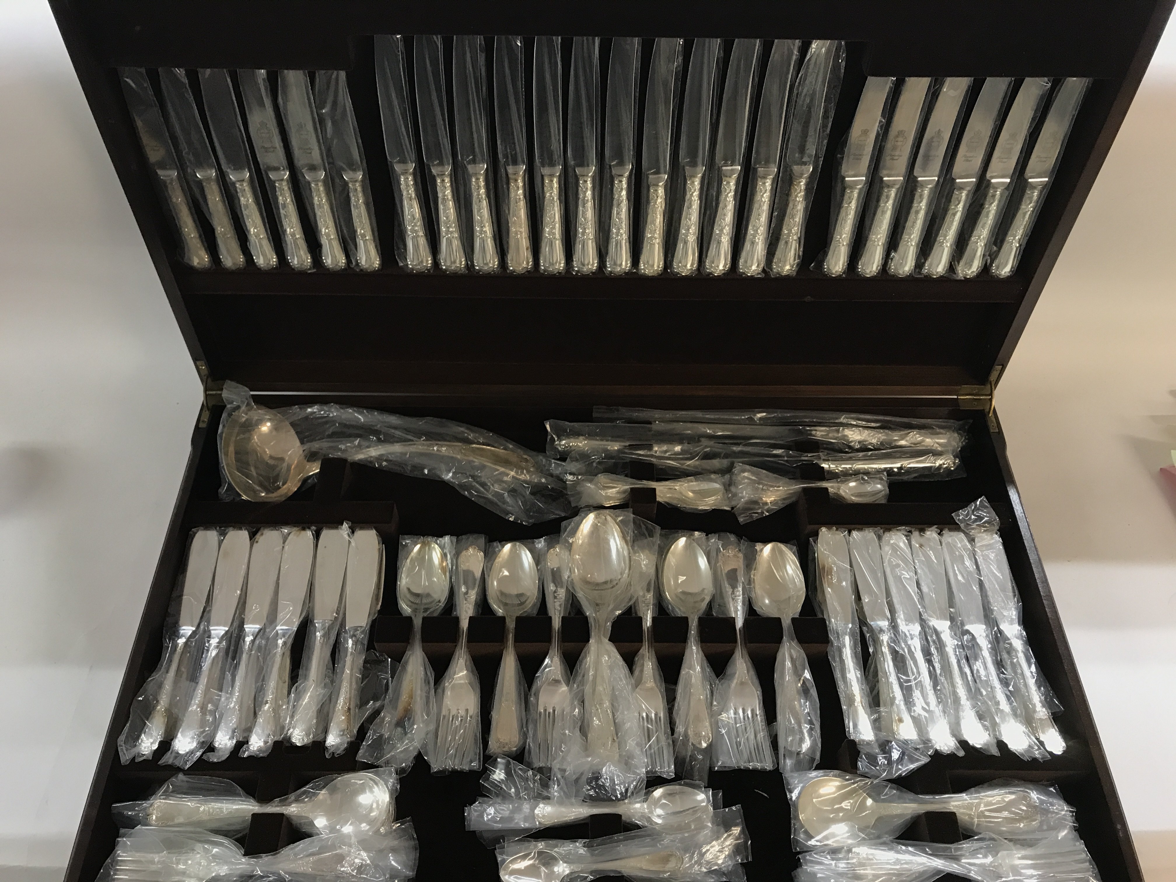 A large cutlery set in table canteen with green le