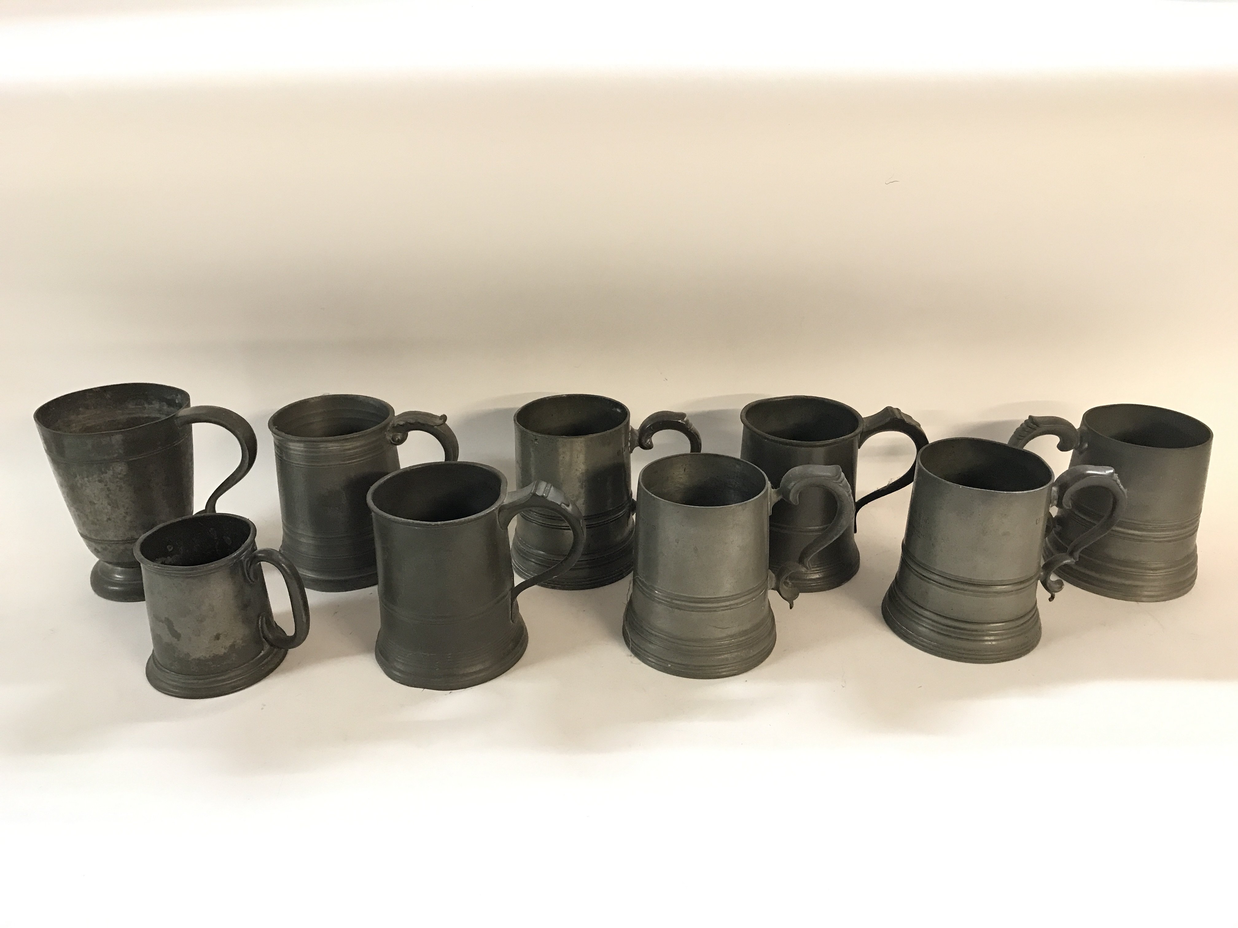 Collection of 19th century and earlier pewter mugs