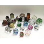 A collection of paperweights including many Wedgwo
