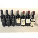 Collection of various red wines including a bottle