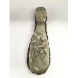 A carved jade sceptre on a hardwood stand, approx