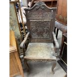 A Victorian carved oak arm chair.