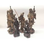 Five carved oriental wooden figures